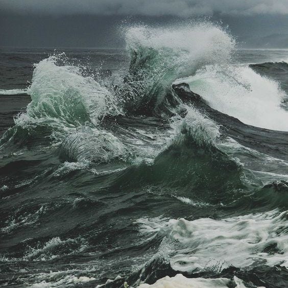 This may contain: a man standing on top of a cliff next to the ocean with text overlay that reads tips for budget friendly hawaiian vacations This may contain: a man standing on top of a cliff next to the ocean with text overlay that reads tips for budget friendly hawaiian vacations