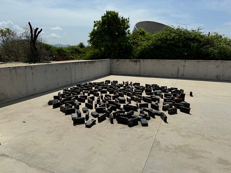 A gallery of images showing art by Bosco Sodi, mostly a collection of concrete and bricks.