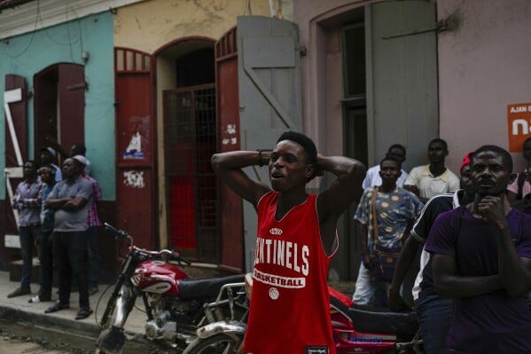 Men watch a soccer match televised in a shop in Cap-Haitien, Haiti, Wednesday, April 17, 2024. (AP Photo/Ramon Espinosa) Men watch a soccer match televised in a shop in Cap-Haitien, Haiti, Wednesday, April 17, 2024. (AP Photo/Ramon Espinosa)