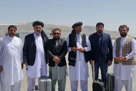 A group of men standing together

Description automatically generated with low confidence