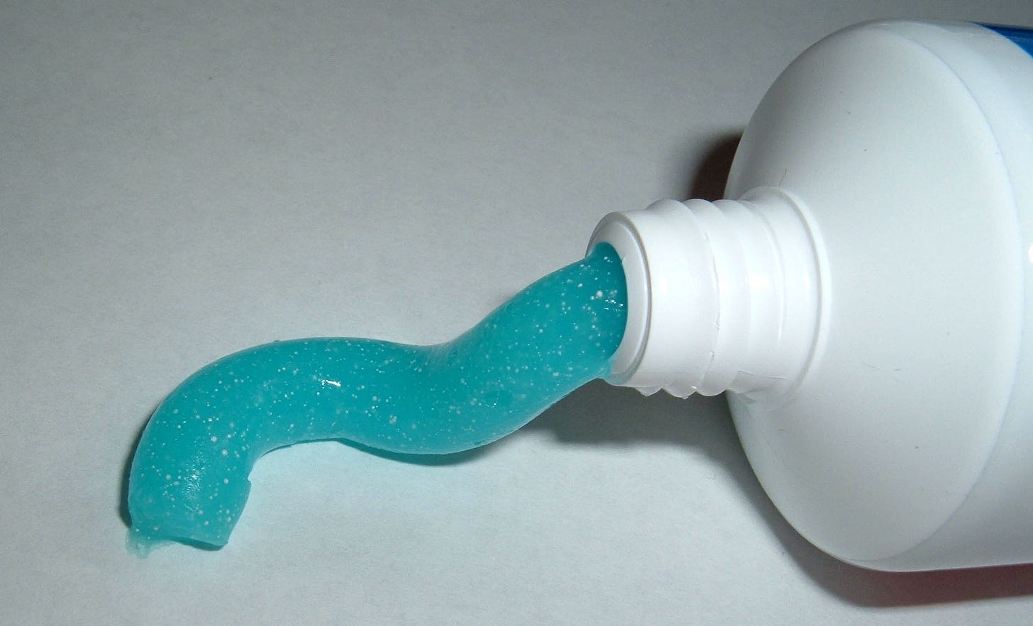 Some toothpaste comes out of a tube