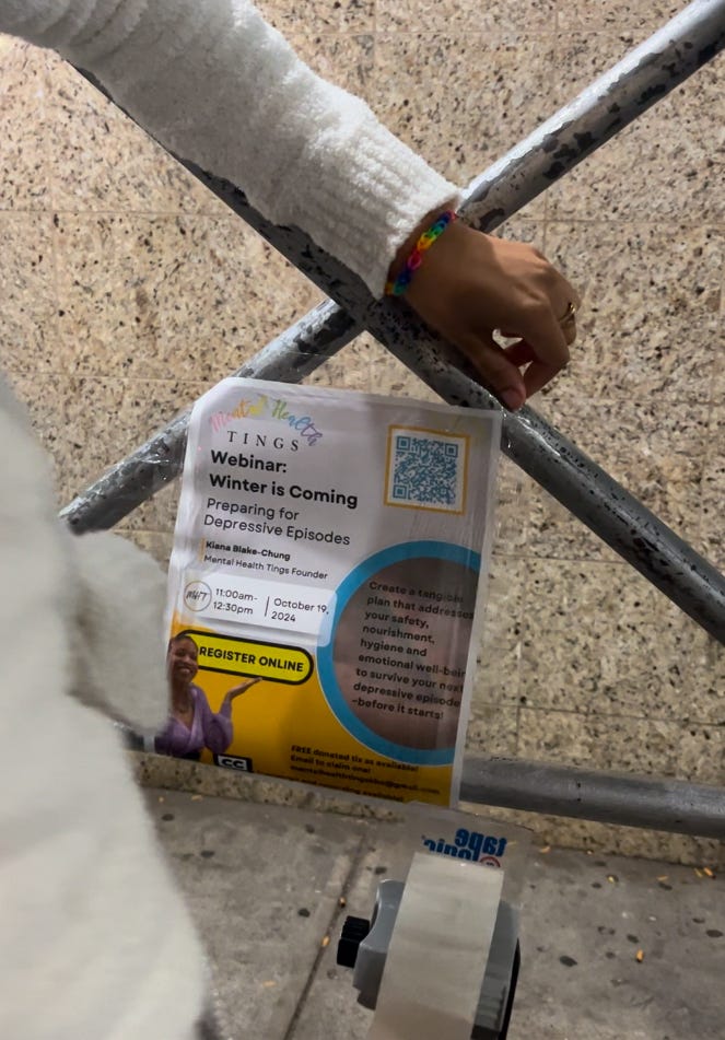 Kiana taping a Preparing for Depressive episodes webinar flyer to some scaffolding
