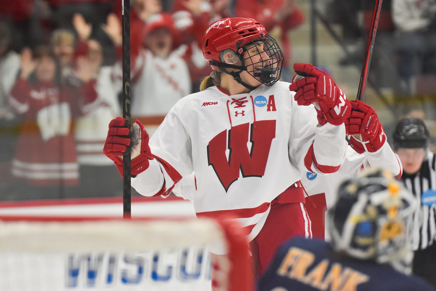 Kelly Gorbatenko smiling and beginning to point to her teammates Kelly Gorbatenko smiling and beginning to point to her teammates