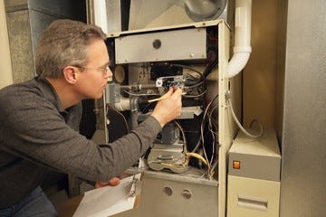 Repairman Checking A Furnace