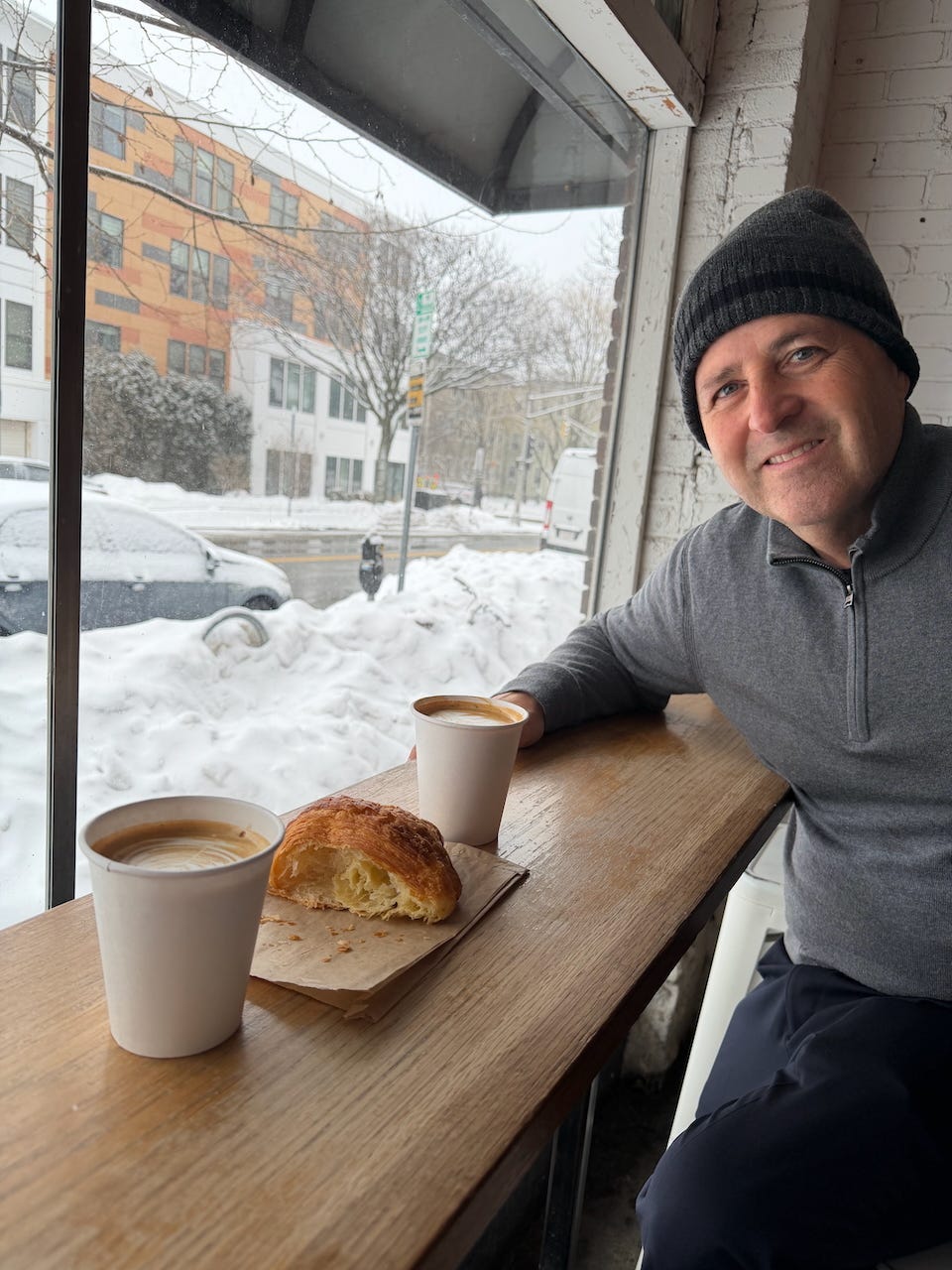 A person sitting at a table with a croissant and coffee

AI-generated content may be incorrect.