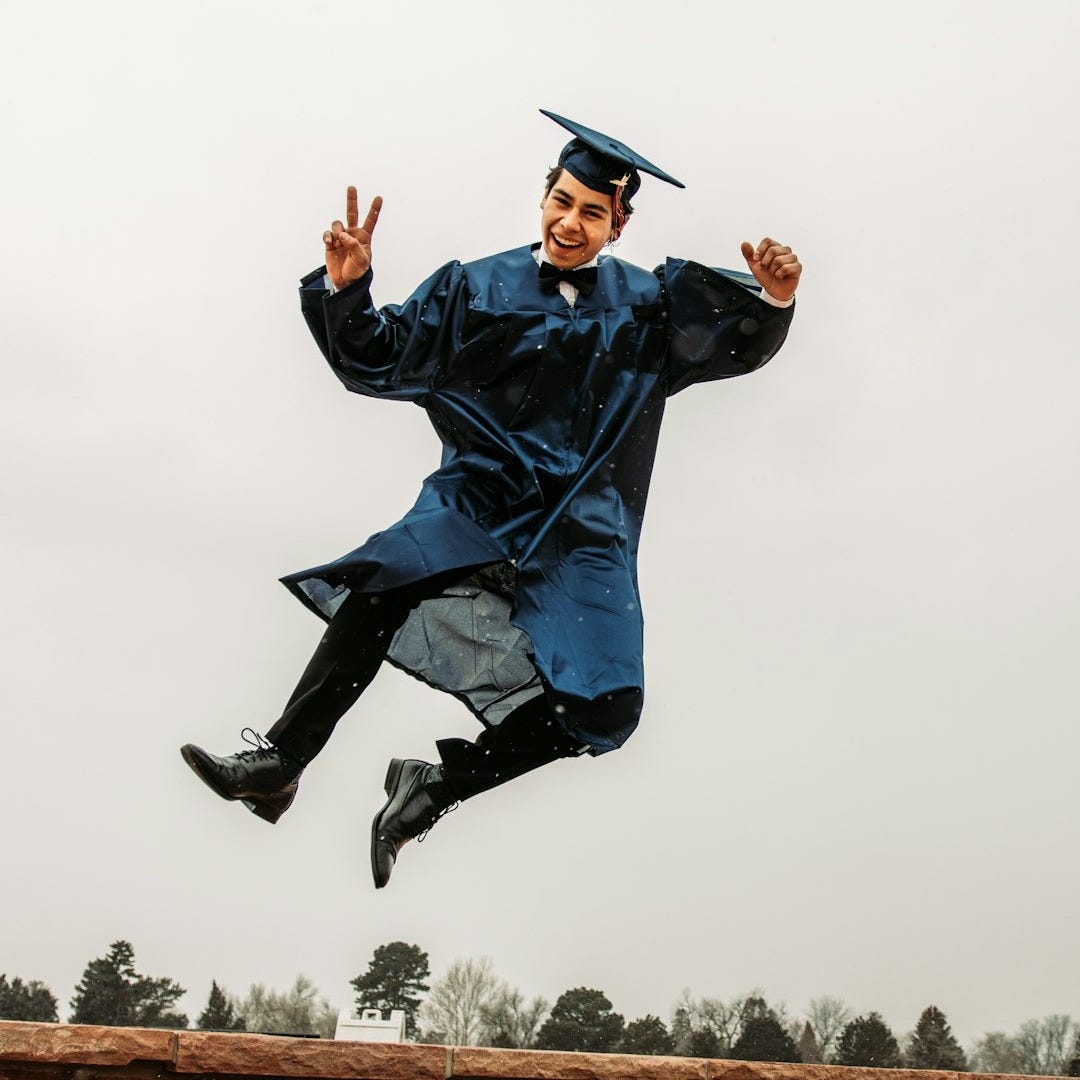 man in black academic dress and black mortar board man in black academic dress and black mortar board