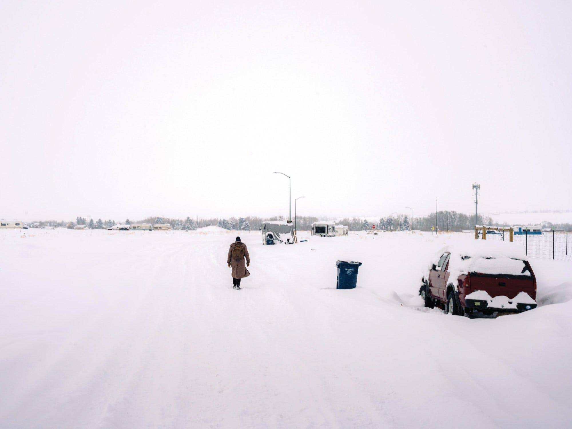 A snowy road in Bozeman, Montana, where unhoused people often park the vehicles they live in. A snowy road in Bozeman, Montana, where unhoused people often park the vehicles they live in.