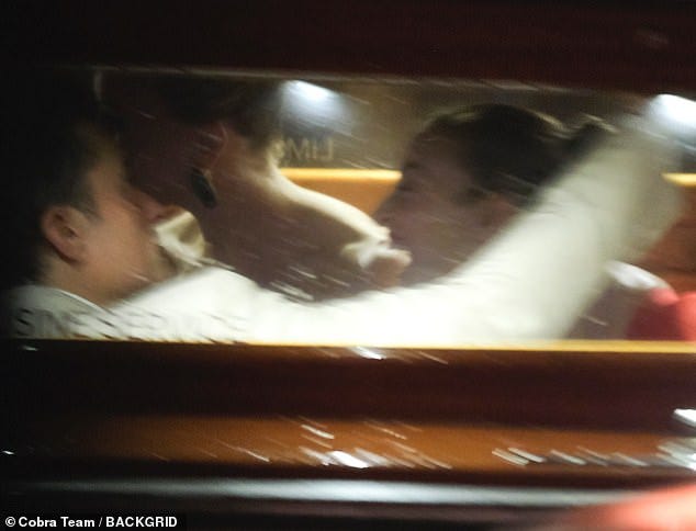 Once inside the boat, Bloom was caught wrapping his arm around the brunette