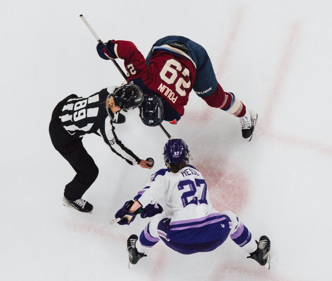Heise and Poulin faceoff.