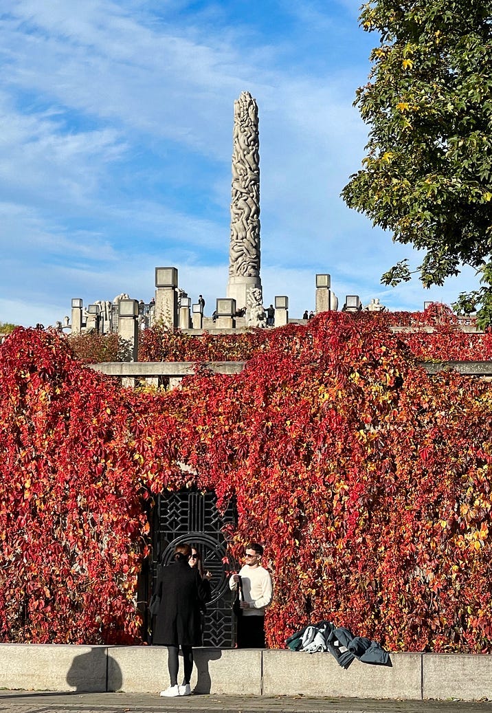 read leaves on the foreground and a monument on the background