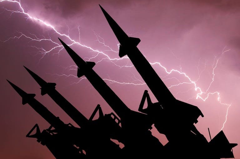 Anti-aircraft missile system are directed upwards against the background of thunderstorm