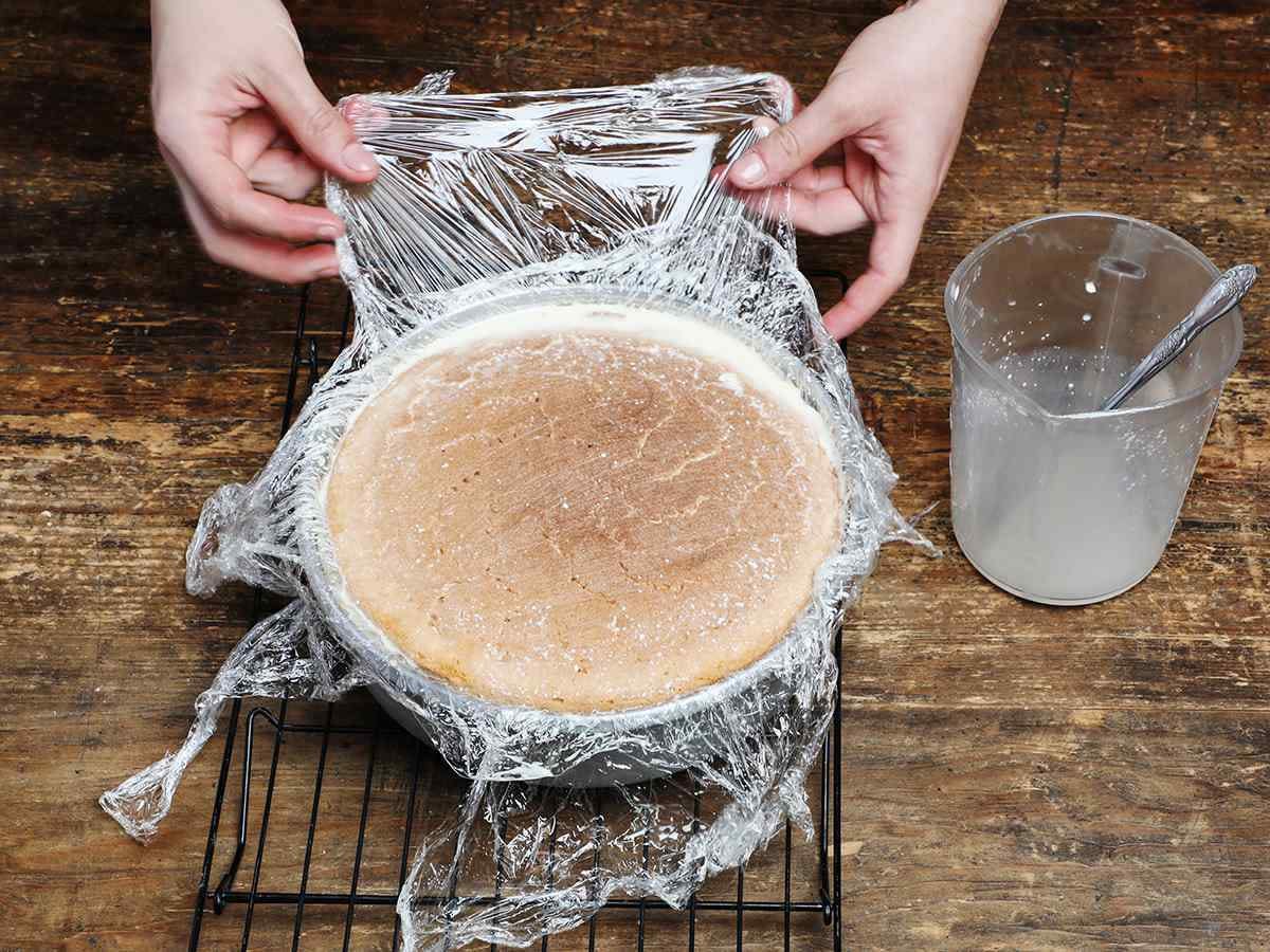 Covering tres leches cake with plastic wrap