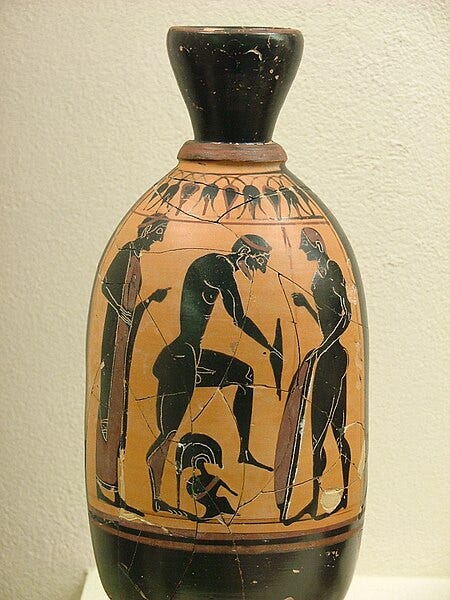 Photograph of a black figure vase with a nude warrior putting greaves on Photograph of a black figure vase with a nude warrior putting greaves on