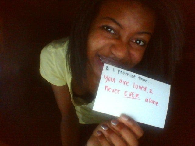 17 year old ari takes a selfie while holding an index card that reads a positive affirmation