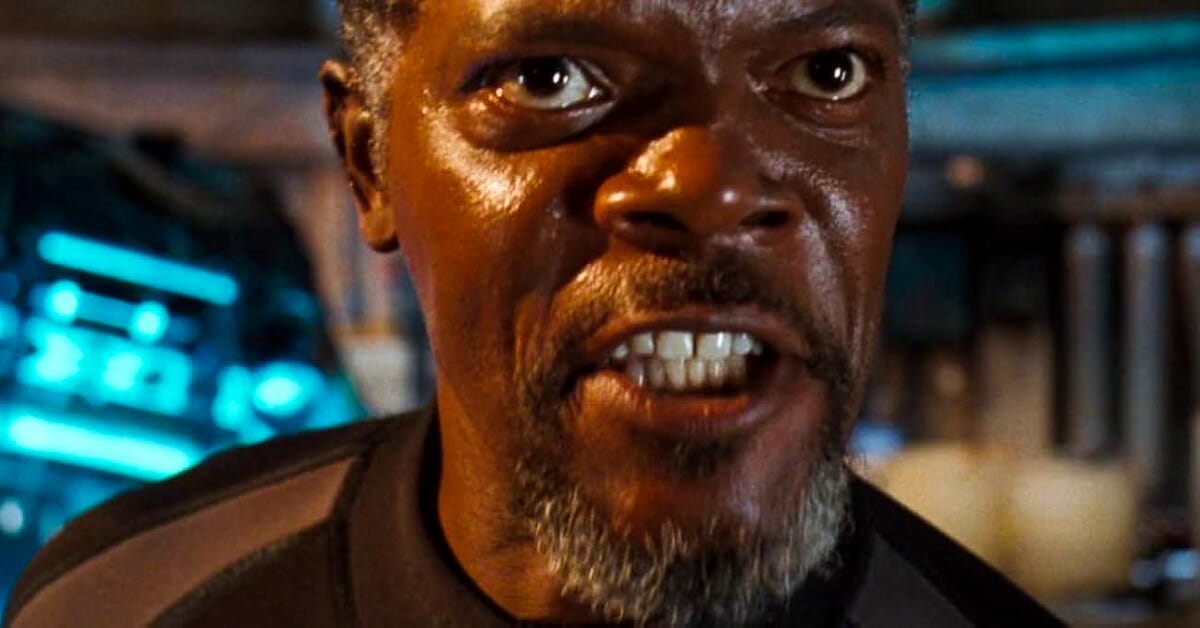 Samuel L. Jackson mid-speech, framed in tense close-up, rallying the group inside the failing research station.