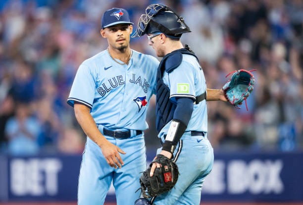 Jordan Hicks and Danny Jansen of Toronto Blue Jays celebrate their win against the Washington Nationals in their MLB game at the Rogers Centre on...
