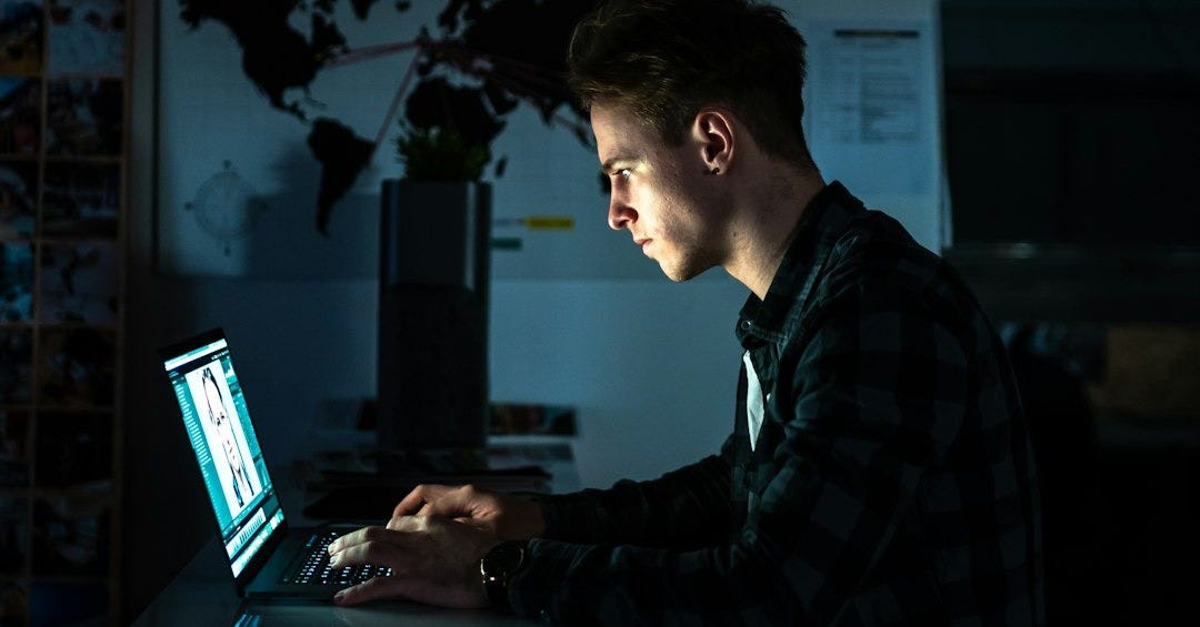 man sitting in front of a computer
