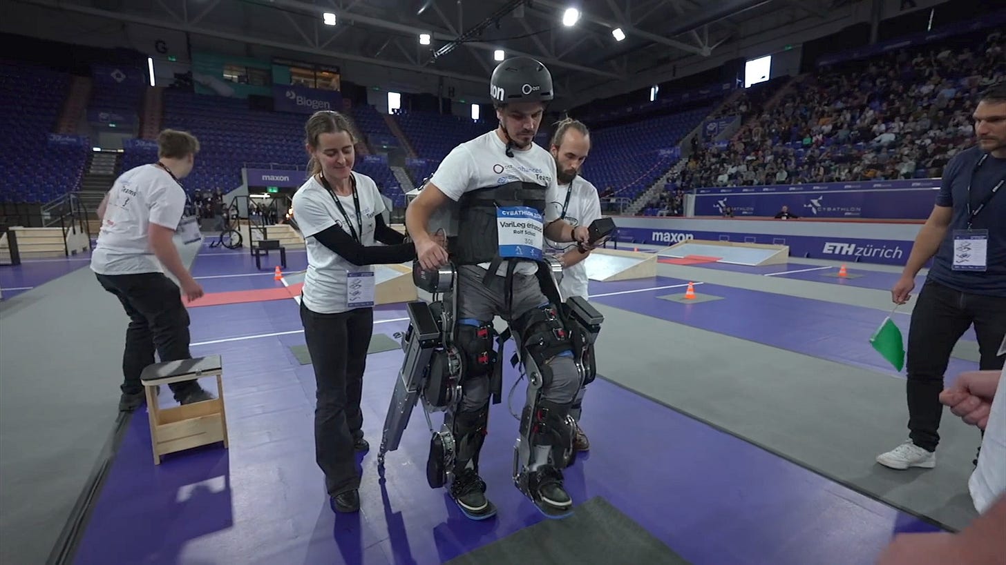 A man wearing 4 robotic legs