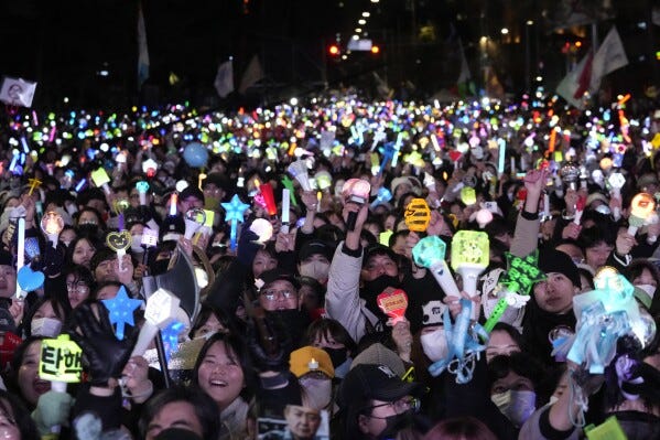 FILE- Participants gather to celebrate after South Korea's parliament voted to impeach President Yoon Suk Yeol outside the National Assembly in Seoul, South Korea, Dec. 14, 2024. (AP Photo/Ahn Young-joon, File)