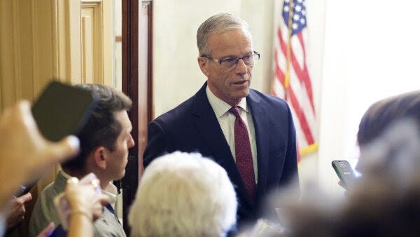 U.S. Senate Majority Leader Sen. John Thune (R-SD) speaks to members of the press at the U.S. Capitol on Oct. 20 in Washington, D.C. He is seen in a blue suit with a purple tie.
