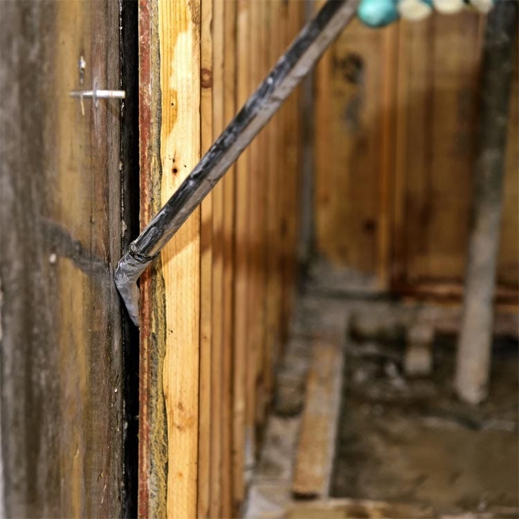 Removing wooden forms from concrete moulds.