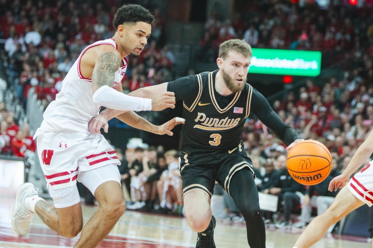boyd defends from smith's right while smith dribbles a basketball in his left hand