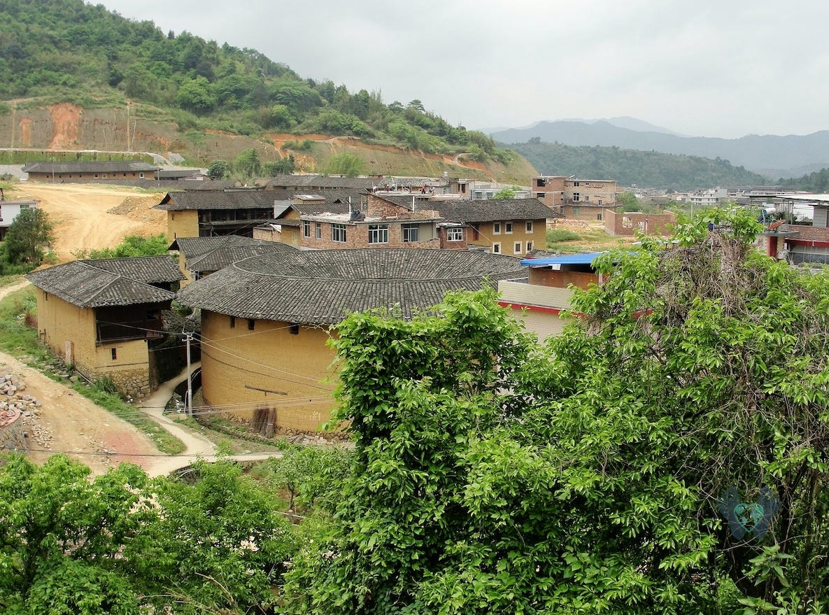 circular Tulou apartment buildings surrounded by forest. Traveling in China. circular Tulou apartment buildings surrounded by forest. Traveling in China.