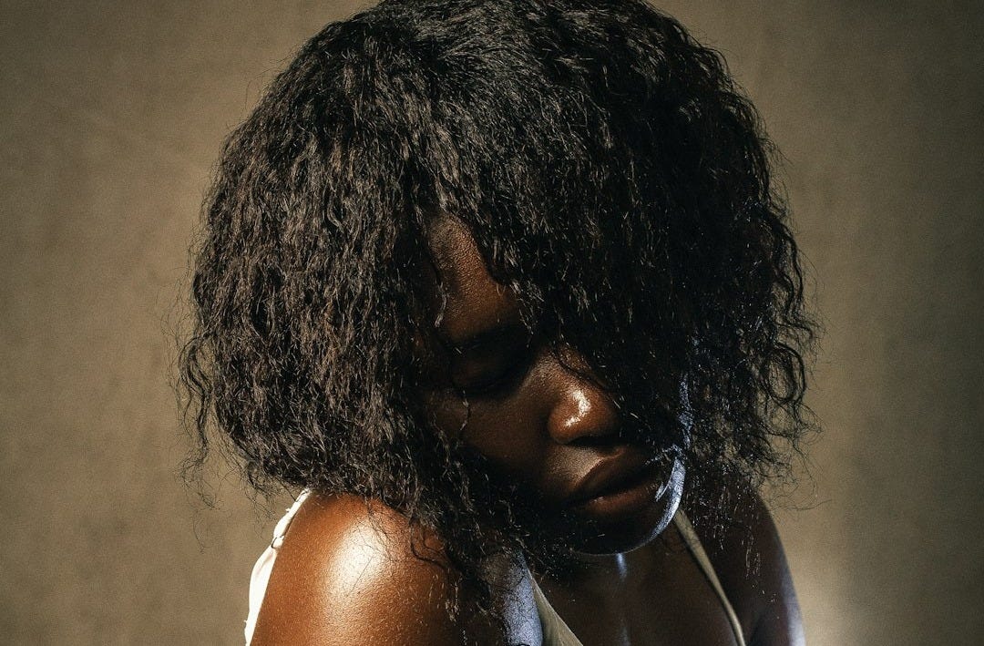 a woman in a white tank top and jeans