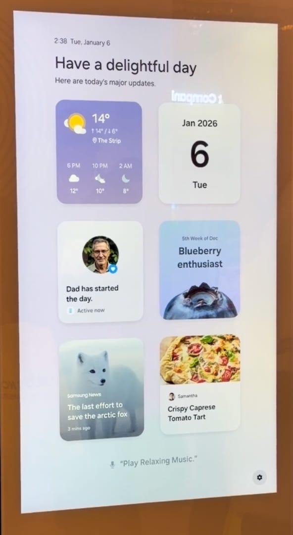 A Samsung AI Family Hub refrigerator displays a recipe for Crispy Caprese Tomato Tart on its touchscreen, while a person points to the ingredient list.