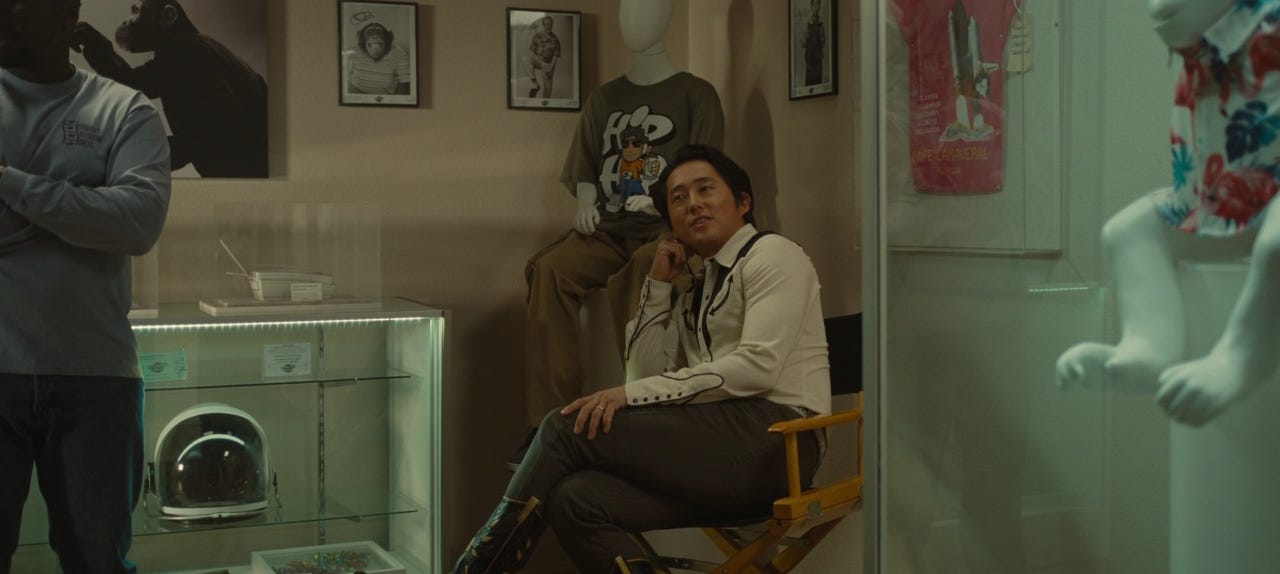 Screenshot from "Nope." The character Ricky "Jupe" Park sits among his collection of "Gordy's Home" merchandise and memorabilia.