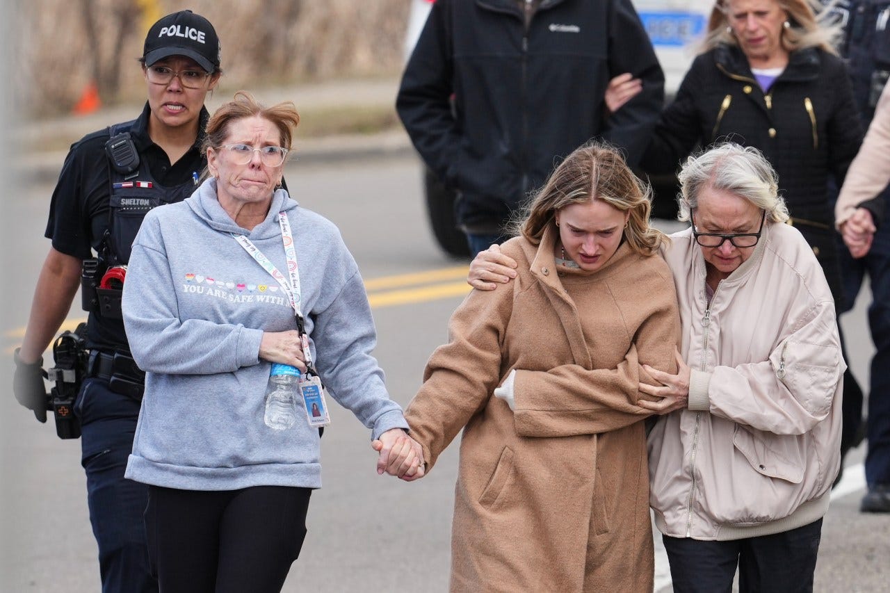 Law enforcement escorts families away from the Temple Israel synagogue on March 12, West Bloomfield Township, Mich. Law enforcement escorts families away from the Temple Israel synagogue on March 12, West Bloomfield Township, Mich.