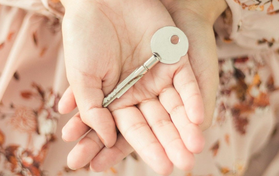 person holding silver and white ballpoint pen
