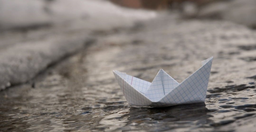 white paper boat on water