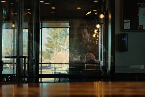 starbucks barista, mirror reflections, man protesting, by Tyler Knott Gregson