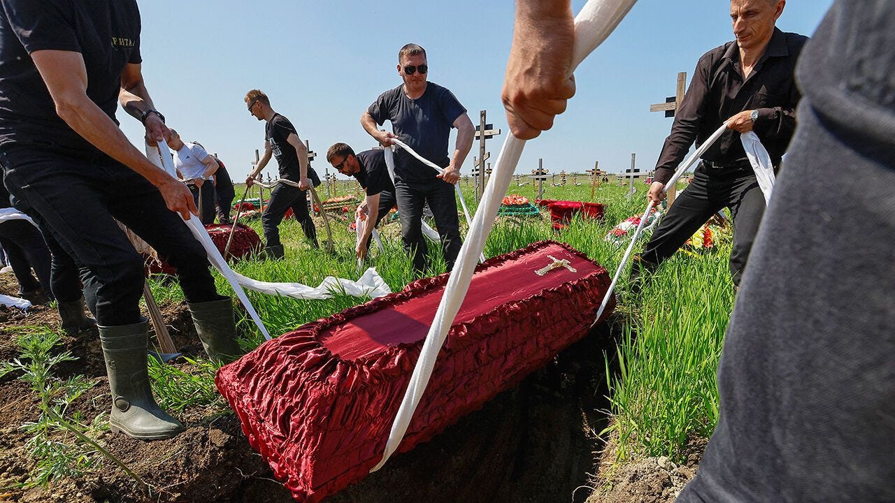A coffin is lowered into the ground - as people take part in a funeral ceremony to bury the remains of 60 Russian soldiers and 3 civilians, killed in the course of Russia-Ukraine conflict, at a cemetery in Luhansk, Russian-controlled Ukraine. A coffin is lowered into the ground - as people take part in a funeral ceremony to bury the remains of 60 Russian soldiers and 3 civilians, killed in the course of Russia-Ukraine conflict, at a cemetery in Luhansk, Russian-controlled Ukraine.