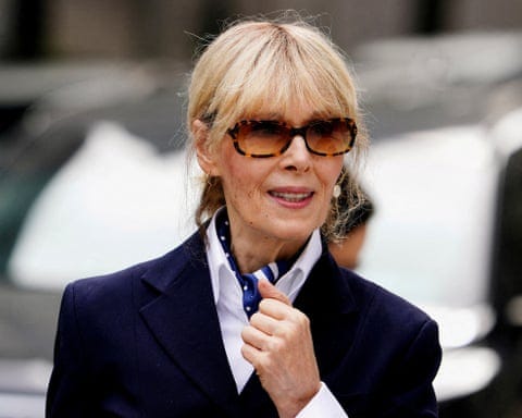 a woman in a blue coat and sunglasses looks off to the side a woman in a blue coat and sunglasses looks off to the side
