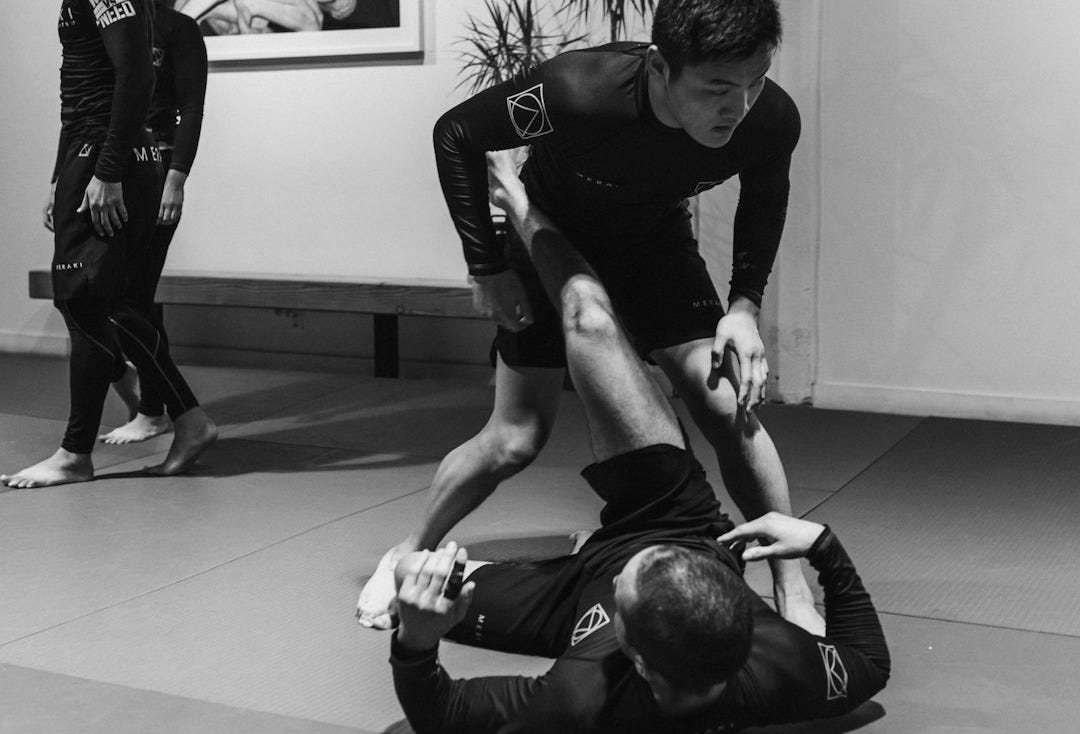 man in black t-shirt and black pants doing push up man in black t-shirt and black pants doing push up
