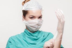 Sexy female doctor in mask and gloves