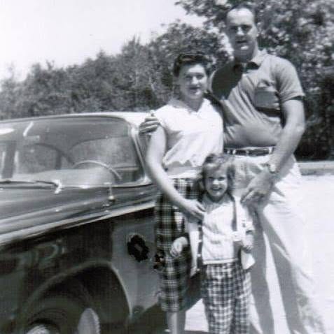 young girl with parents and car in late 1950's young girl with parents and car in late 1950's