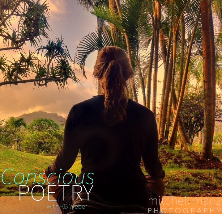 Back of meditating woman during sunrise in kauai with oranges and yellow hues. Kauai mountains, palm and bamboo trees frame her
