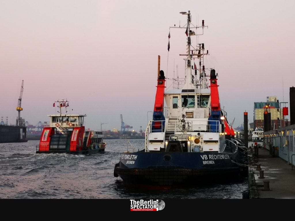 Boats move in the Elbe river early in the morning.