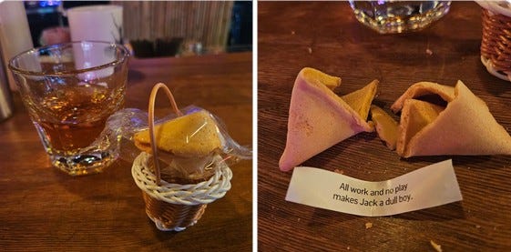 First photo: a cocktail in a tumbler next to a fortune cookie in a miniature basket; second photo: the opened cookie, the fortune reading "All work and no play makes Jack a dull boy."