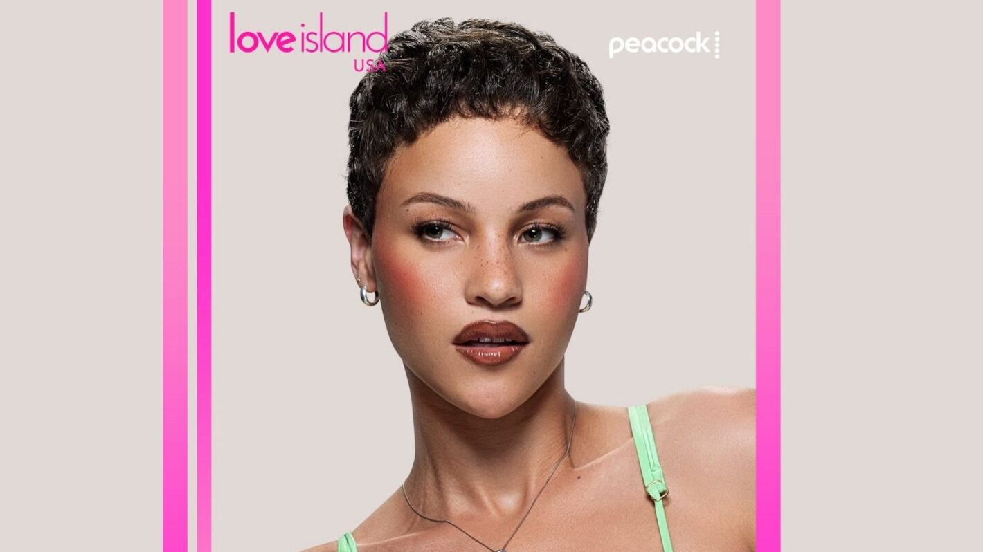 Promotional portrait for Love Island USA featuring a contestant with short dark hair, hoop earrings, and a mint-green top. The person is posed against a light gray background, looking off to the side. Pink vertical borders frame the image, with the Love Island USA logo at the top left and the Peacock logo at the top right.