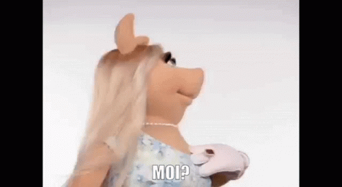 miss piggy from the muppet show is wearing a blue dress and white gloves and talking . miss piggy from the muppet show is wearing a blue dress and white gloves and talking .