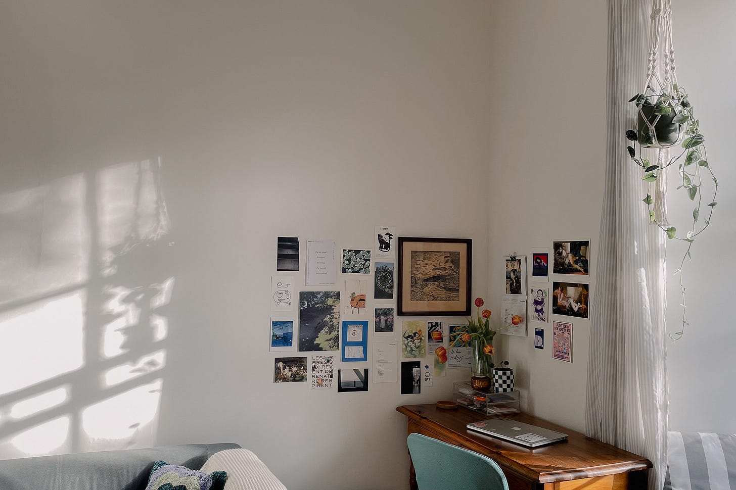 My desk area in the living room with soft shadows on the wall, created by the natural light hitting the space.