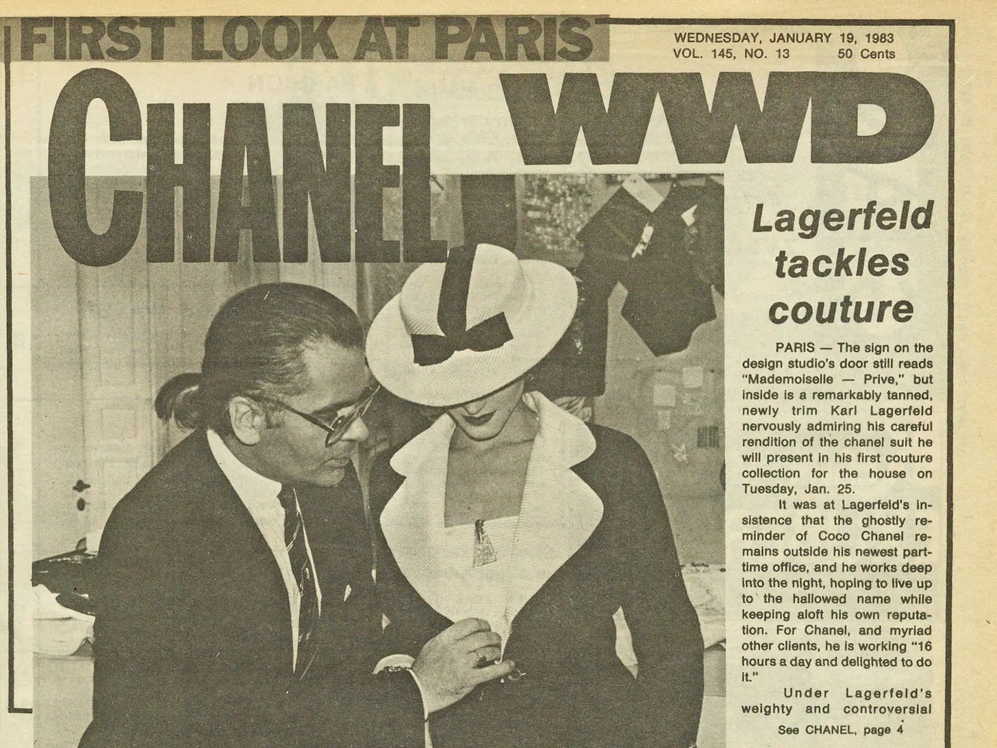 A yellowed vintage WWD cover from 1983 depicting designer Karl Lagerfeld as he prepares a model wearing clothes from his first couture collection for Chanel.