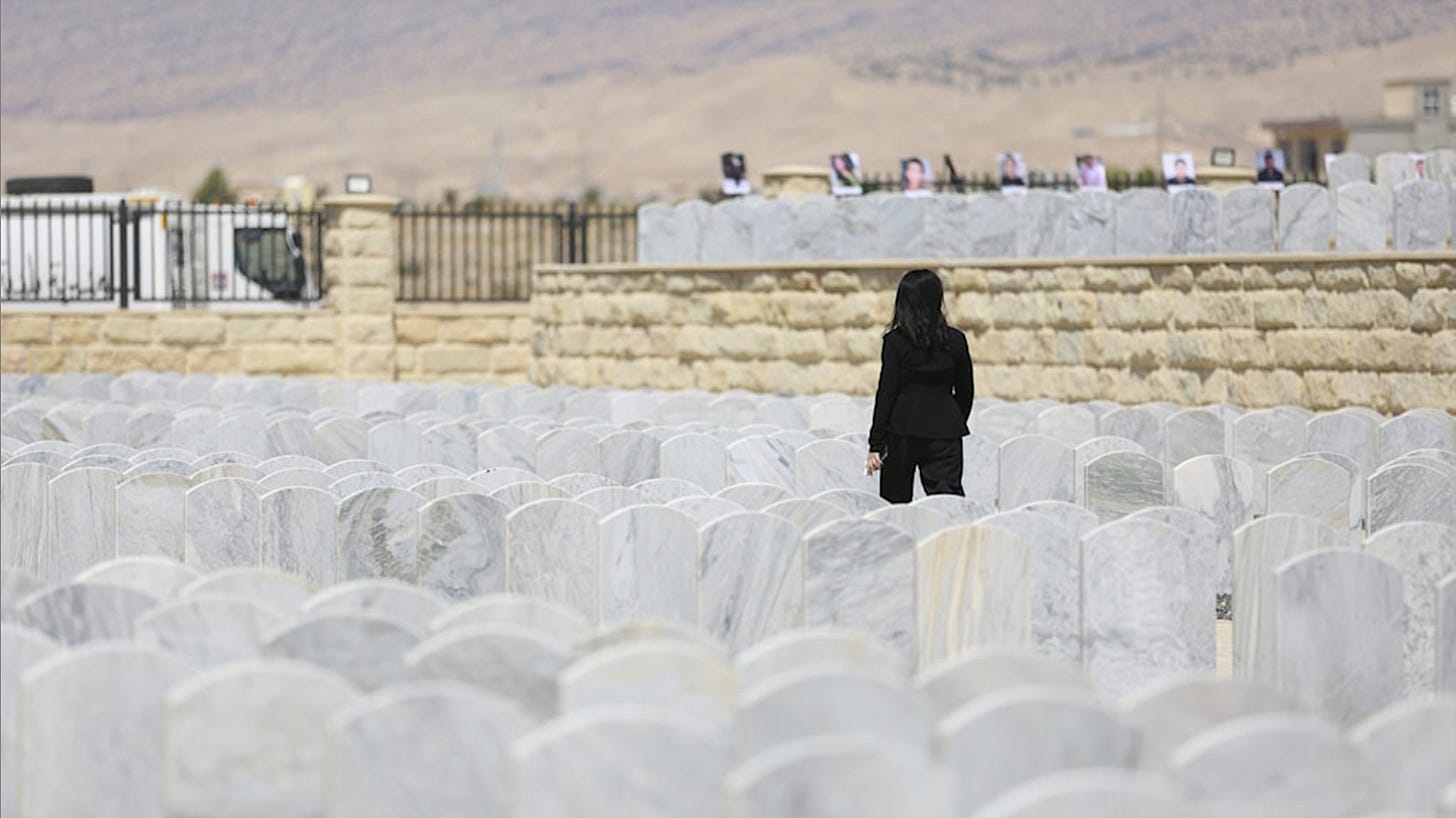 An Iraqi Yazidi woman visits her relatives in the cemetery during a commemoration of the 10th anniversary of Yazidi genocide in Sinjar. (Photo: AP)