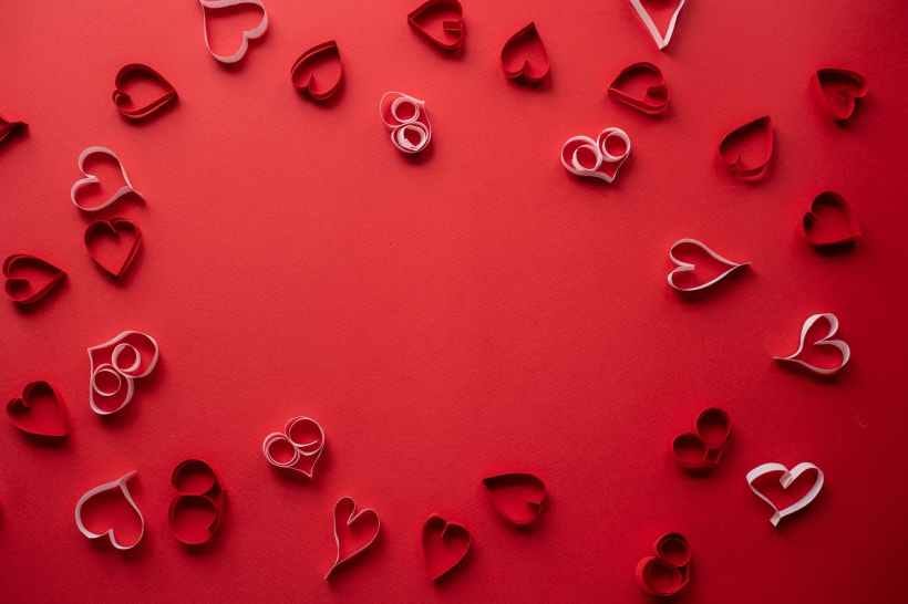 Valentine's Day heart decorations on a red background.