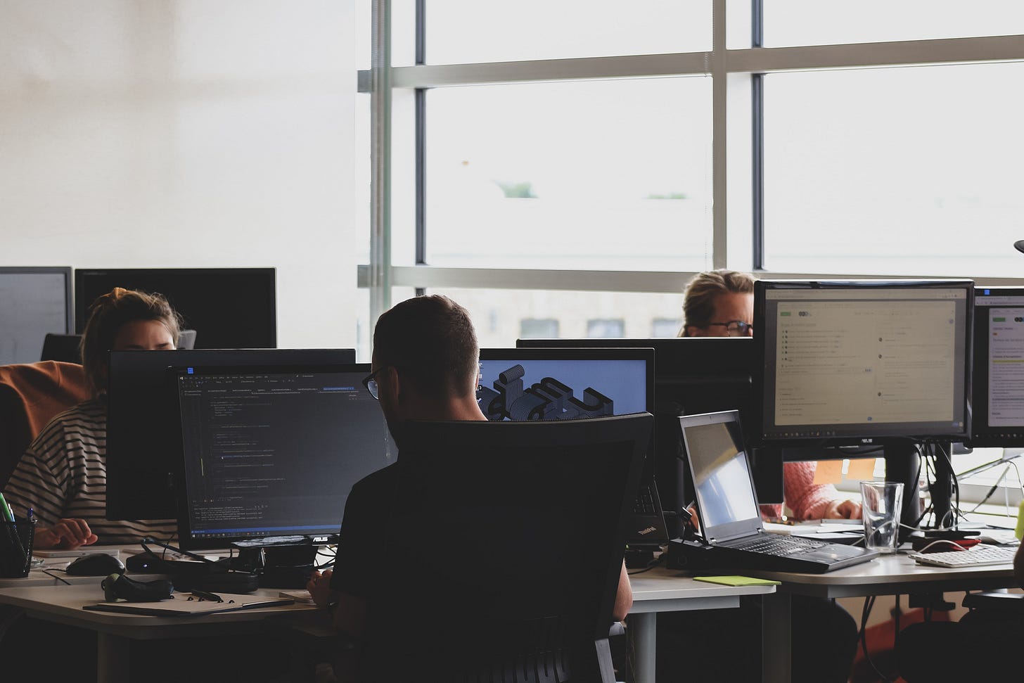 Image of people in an office working on computers Image of people in an office working on computers