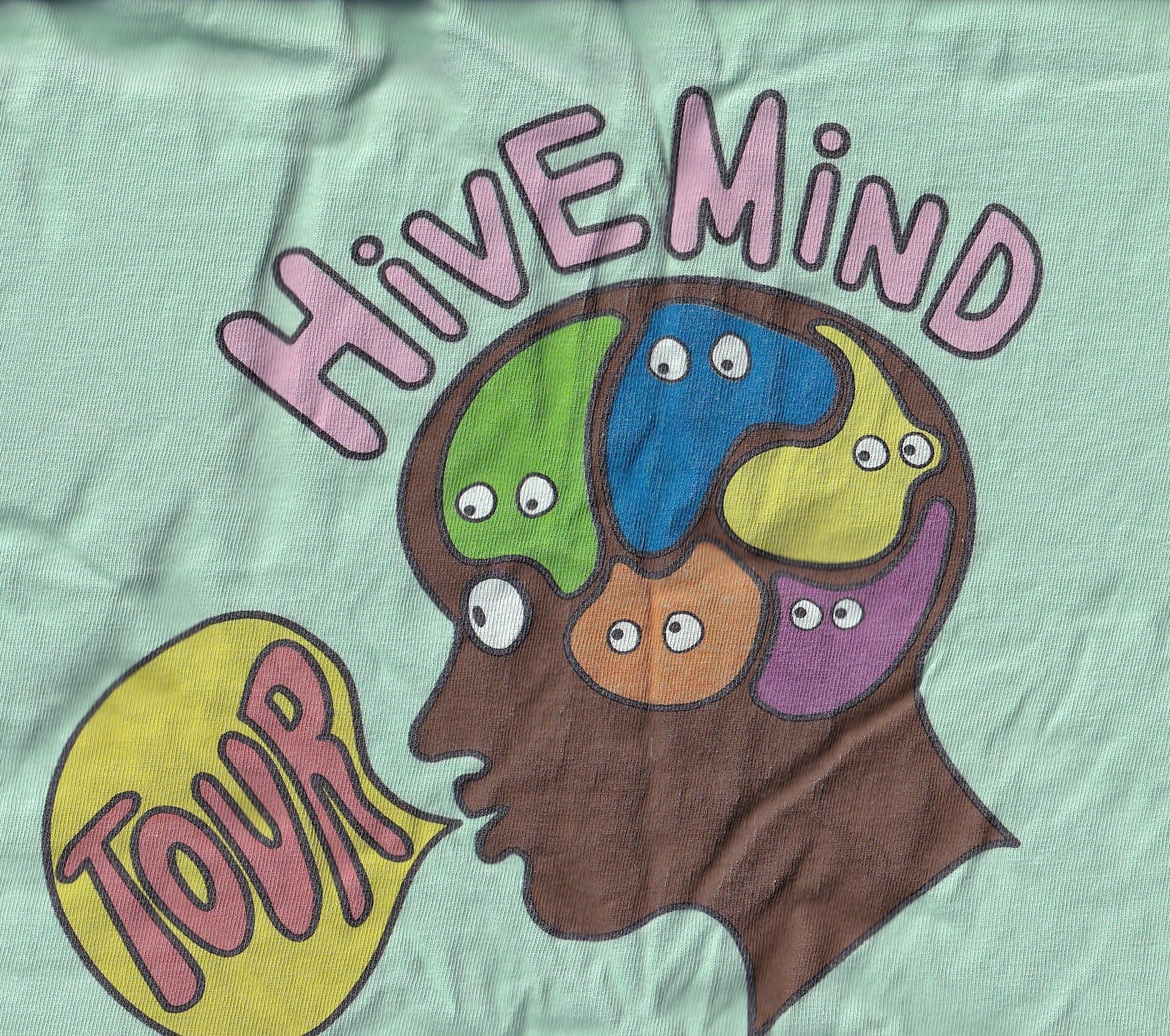 a scan of my mint green t-shirt from The Internet's Hive Mind Tour (2018) featuring a phrenology head with a speech bubble and colorful blobs inside the brain